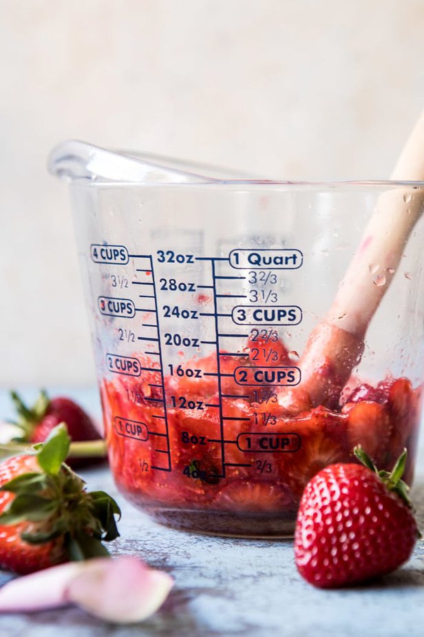 muddled strawberries for rose cider cocktail