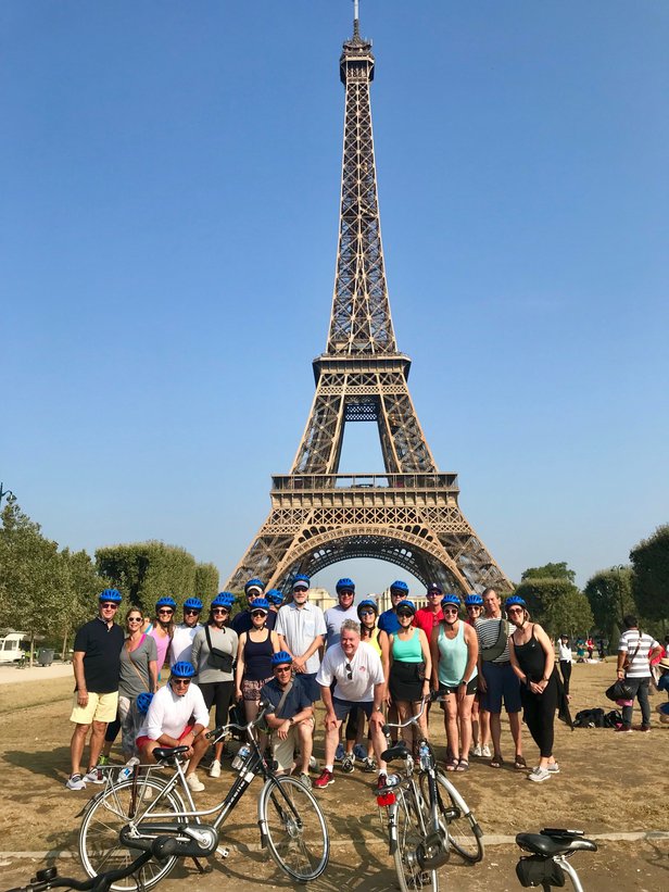 roman and tour group in front of eiffel tower